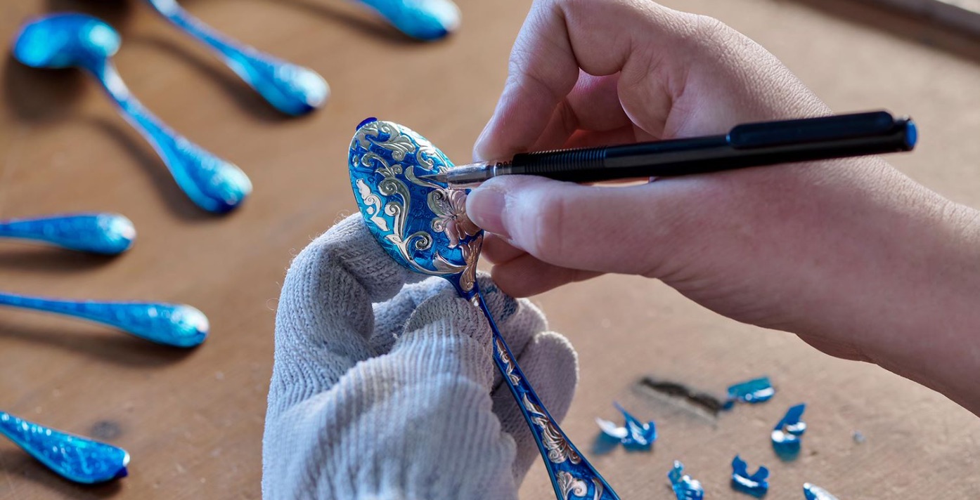 A craftsperson details an ornate Christofle spoon
