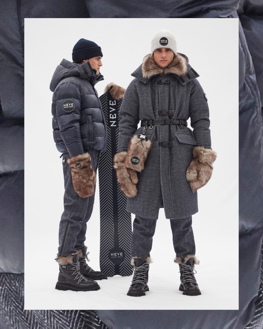 Two men pose in dark grey fur-lined coats and snow boots from Armani's FW21 Collection