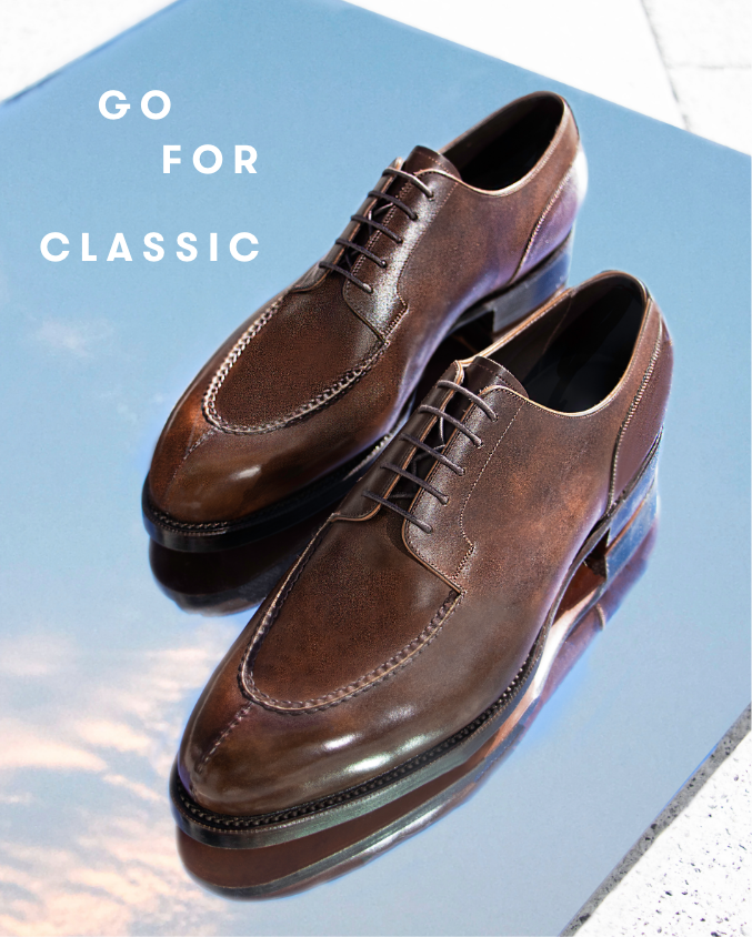 Crockett & Jones shoes on top of mirror showing sky