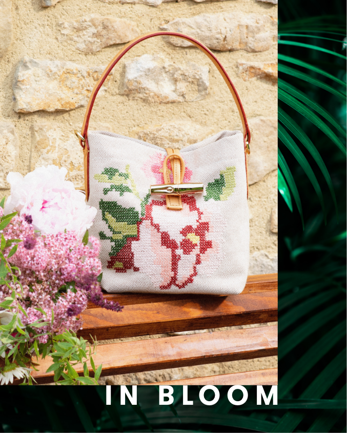 Longchamp Bucket Bag sitting on wooden furniture, In Bloom