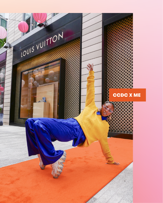 Neema Rowe doing a dynamic pose while standing orange carpet